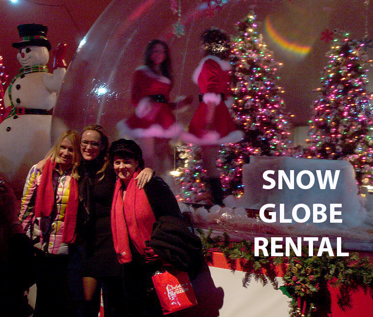 Life-size inflatable snow globe for rent featuring Christmas with the Kranks themed backdrop for holiday photo opportunities