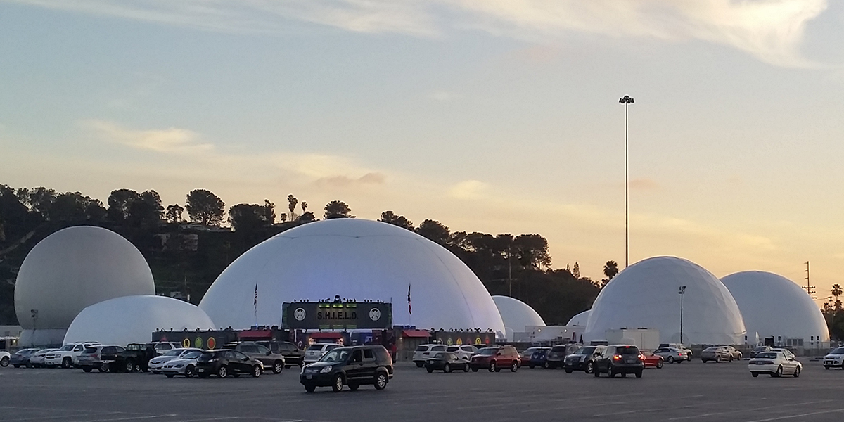 Seven linked inflatable event domes forming a single traveling immersive campus — The Marvel Experience touring deployment