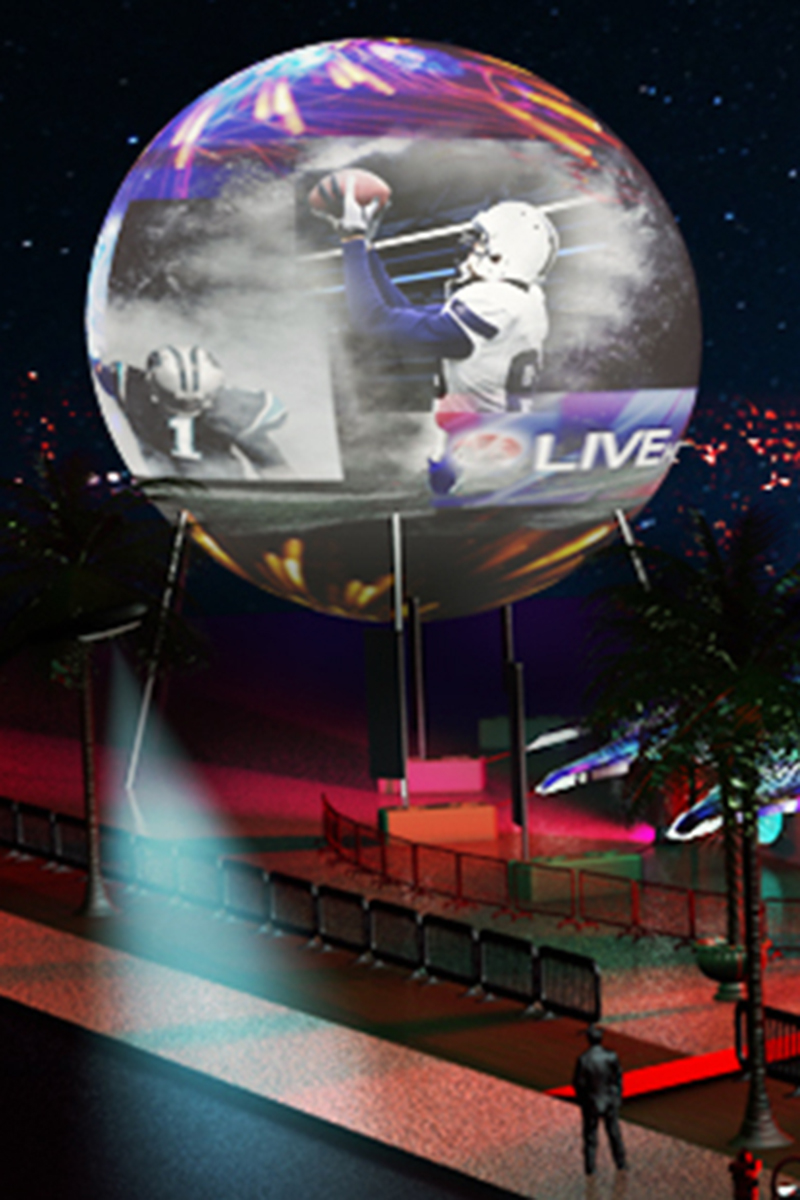 Large outdoor projection sphere 83 feet tall displaying football goalkeeper making save with LIVE branding at outdoor stadium venue with elevated positioning for FIFA World Cup and major football championship activations