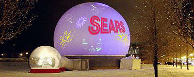 Sears logo projected on Absolute Hollywood StratoSphere dome with airlock snow globe in foreground — Millennium Park Chicago winter festival 2002
