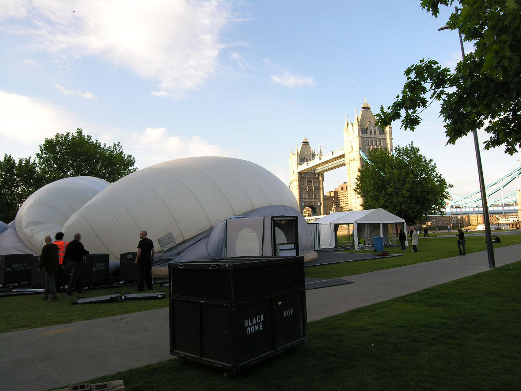 Absolute Hollywood projection dome installation in progress near Tower Bridge London, Athens Tour May 2009, dome mid-inflation with flight cases