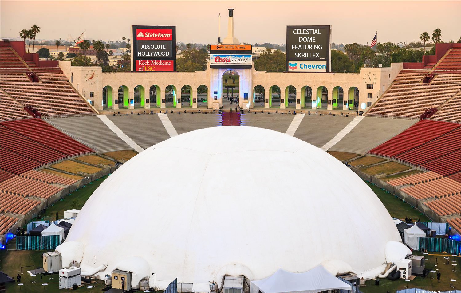 Aerial view of the 235 ft Celestial dome filling the field of the LA Memorial Coliseum, scoreboards announcing the Skrillex show
