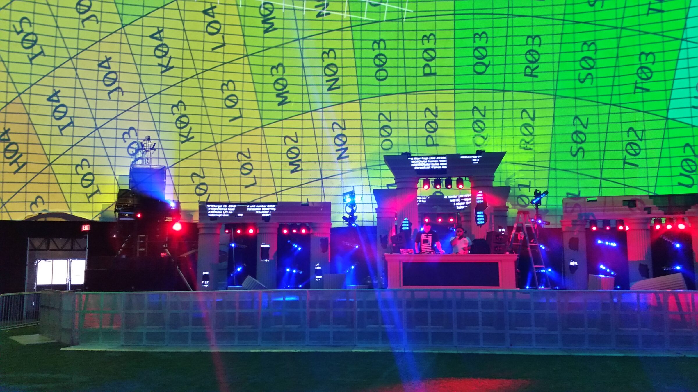 Green and yellow alignment grid with numbered sectors glowing above the stage set inside a vast dome
