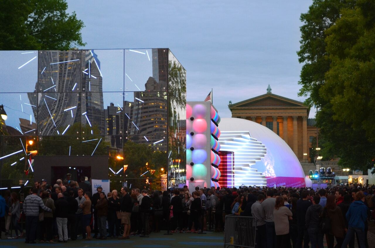 Five Future Sensations pavilions at The Oval with the Philadelphia Museum of Art beyond — Absolute Hollywood immersive dome among them