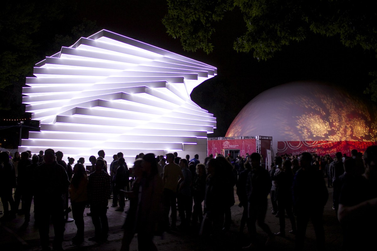 Large projection dome at night in Philadelphia, Pennsylvania — Absolute Hollywood 75 ft dome lit for Saint-Gobain Future Sensations