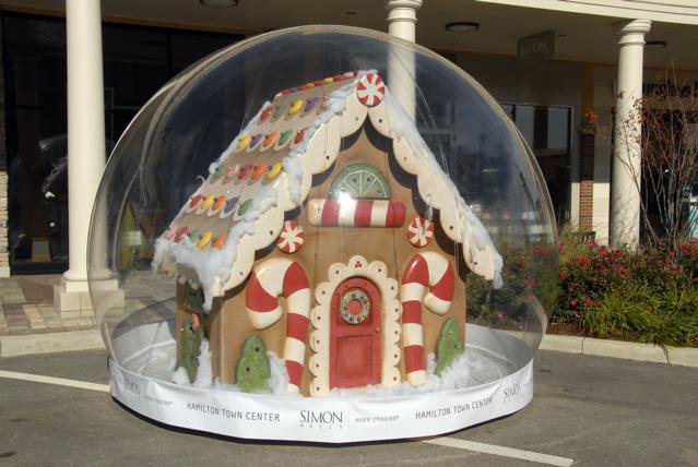 Twelve foot giant snow globe holding a gingerbread house created by Hilton's pastry chef, displayed at Hamilton Town Center