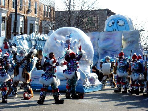 Award-winning giant snow globe on a Mummer's Day Parade float in Philadelphia with costumed string band performers in front