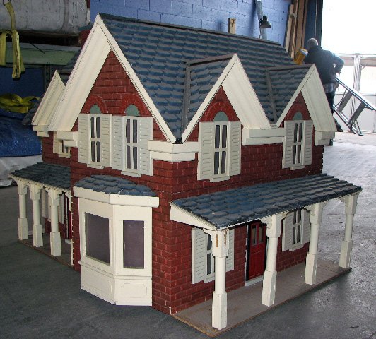Custom model house with brick walls and shingle roof under fabrication for a client's giant snow globe at Absolute Hollywood
