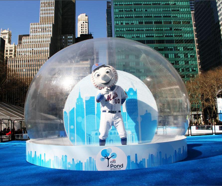 Giant snow globe at Citi Pond Bryant Park New York with the Mets mascot inside and a printed city-skyline base wrap