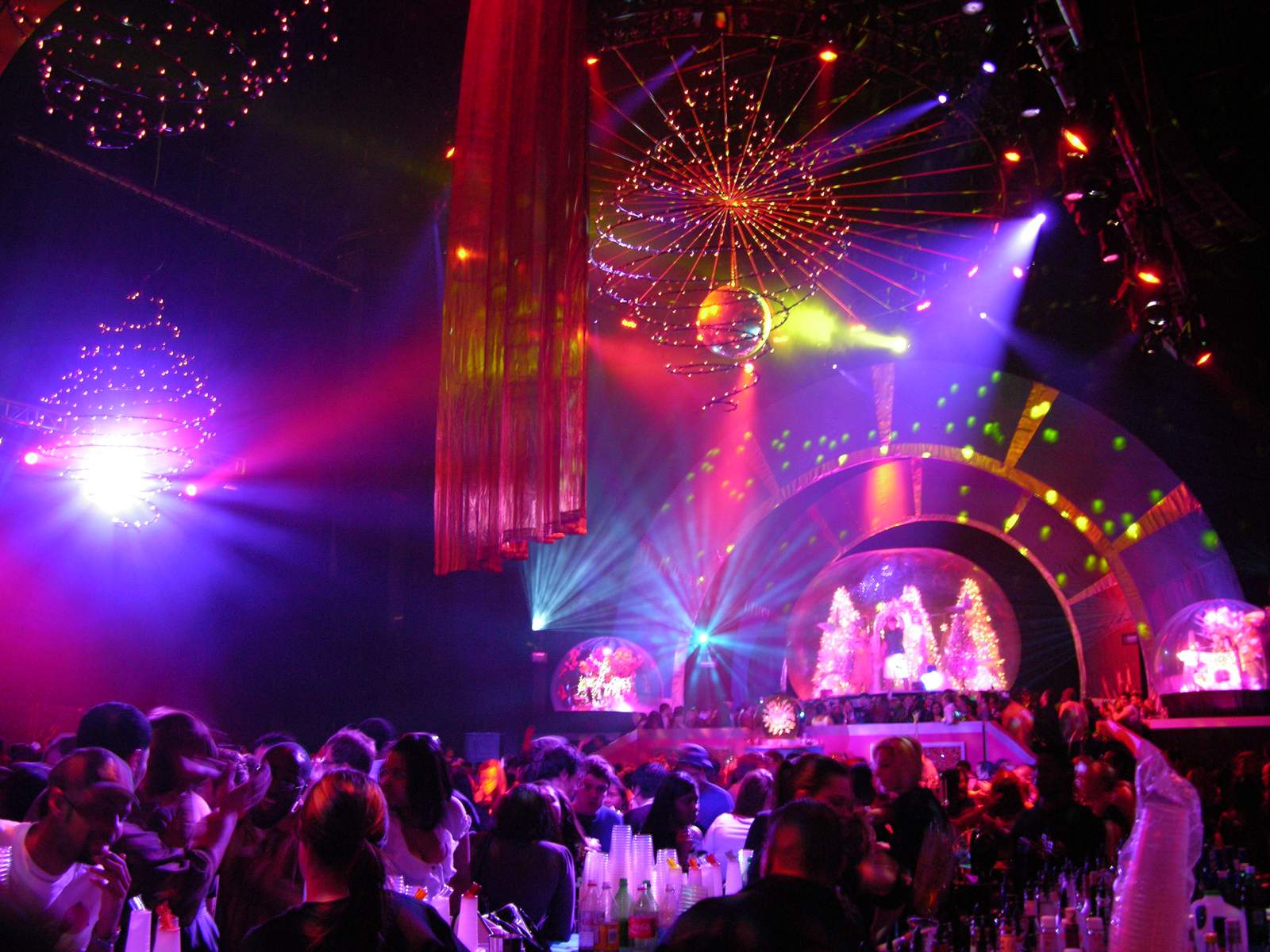 Giant snow globe lit as the stage centerpiece at the MTV holiday party in New York with guests gathered in front