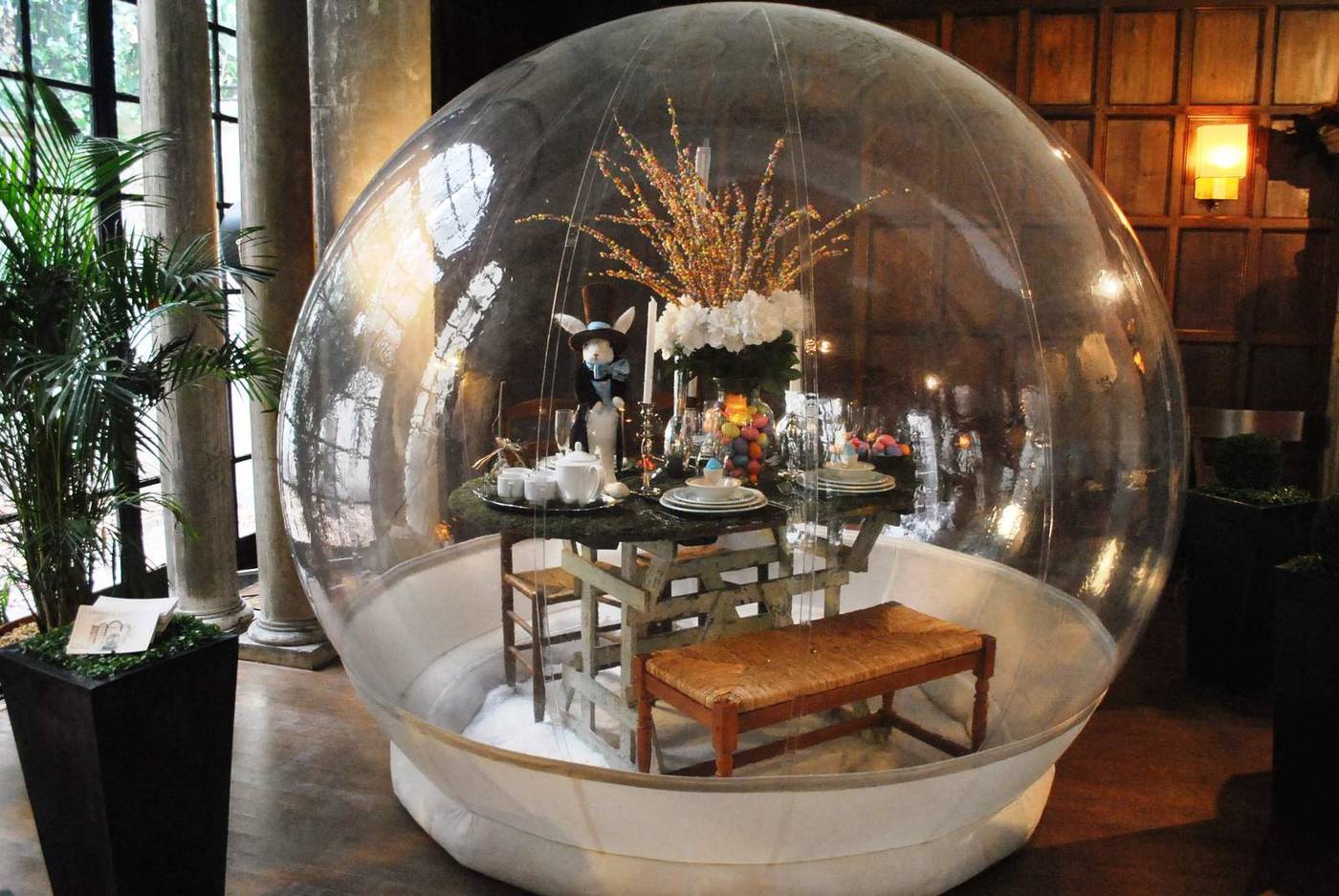 Award-winning giant snow globe display for Robin Wilson Home in New York City with a table and chairs set inside