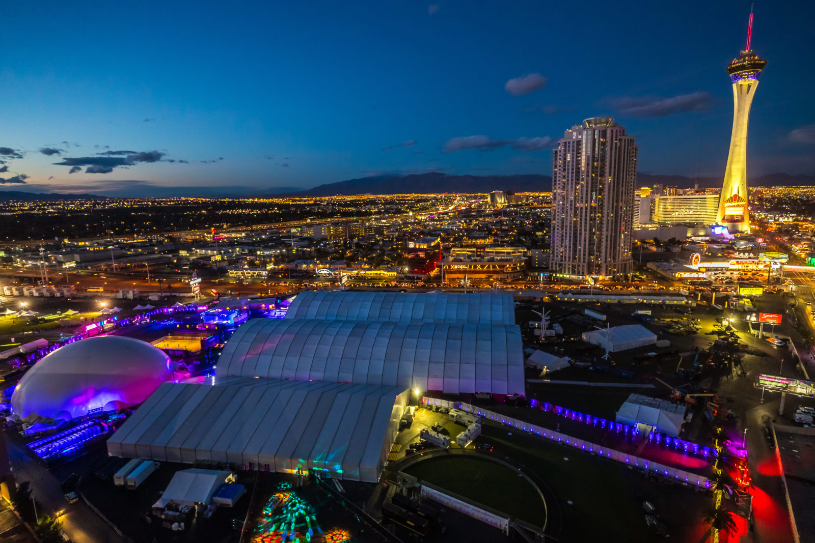 Night aerial of the Amazon corporate activation with a projection dome rental against the Las Vegas skyline.