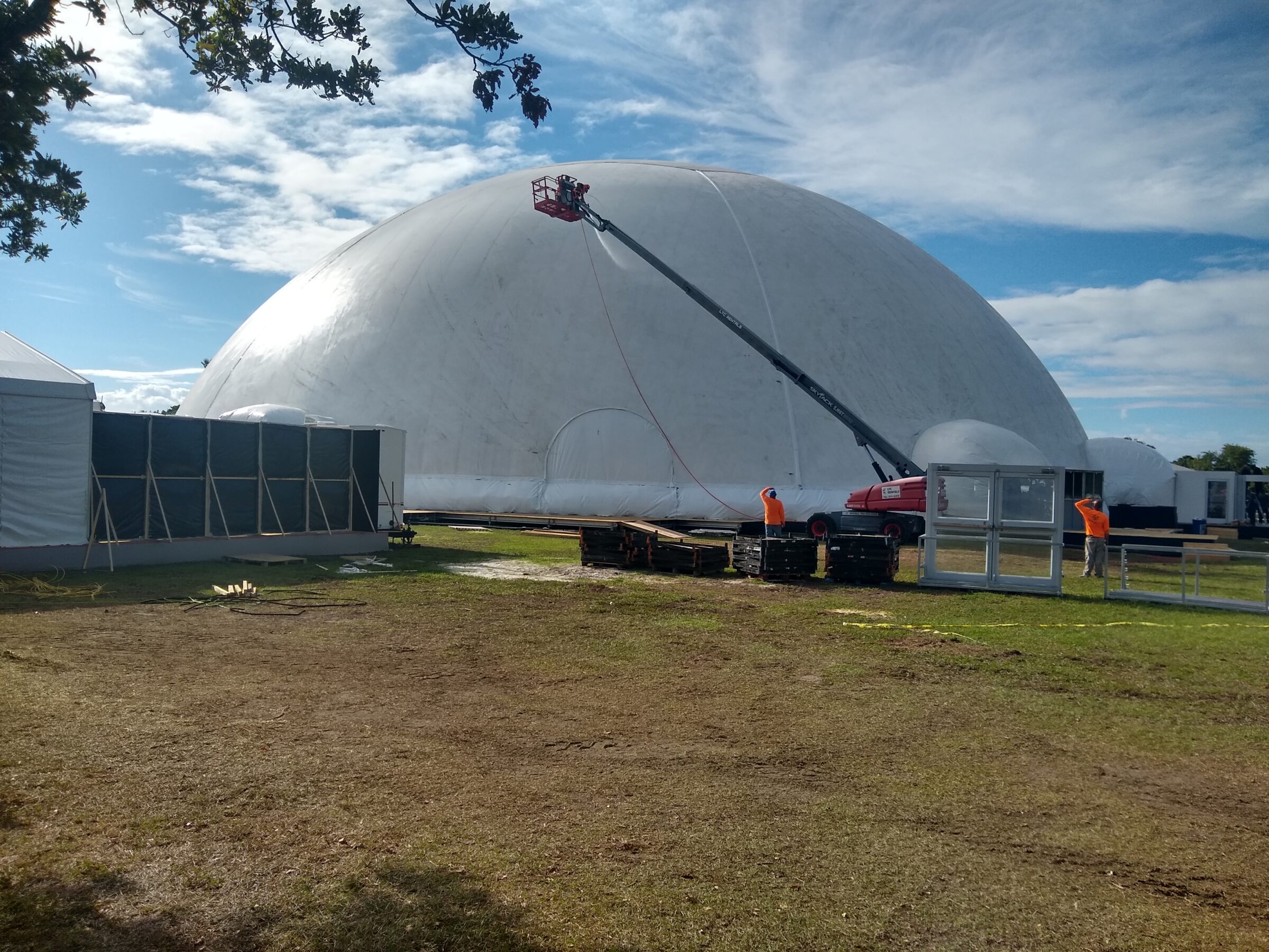 Crane working over a large white Celestial projection dome rental during installation in Miami, 2023.