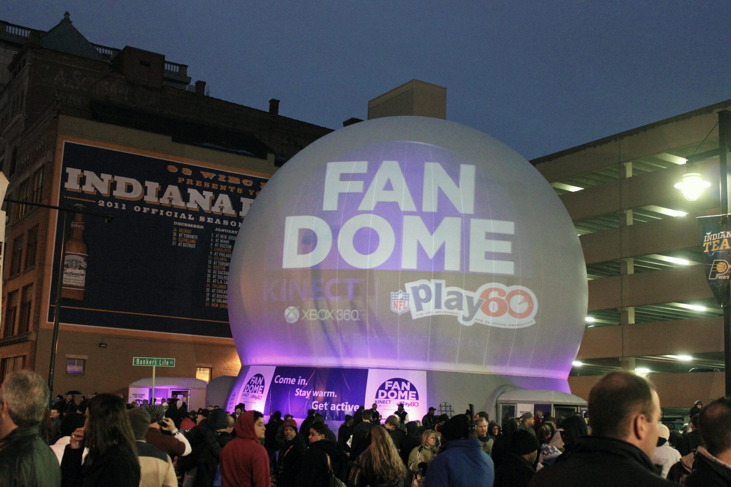 Crowd entering the Microsoft Kinect FanDome projection dome rental at Super Bowl XLVI in downtown Indianapolis at dusk.