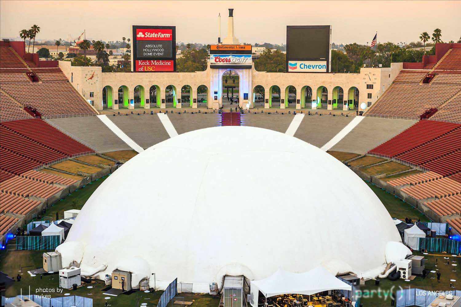 Aerial view of the 235 ft Celestial projection dome filling the LA Memorial Coliseum field — the largest portable projection dome