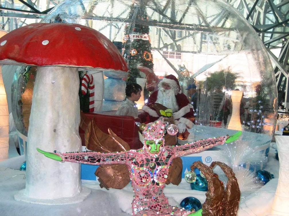 Interior of a snow globe rental styled with a red canopy, blue ornaments and product pieces for a retail activation